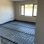 underfloor heating pipes being installed